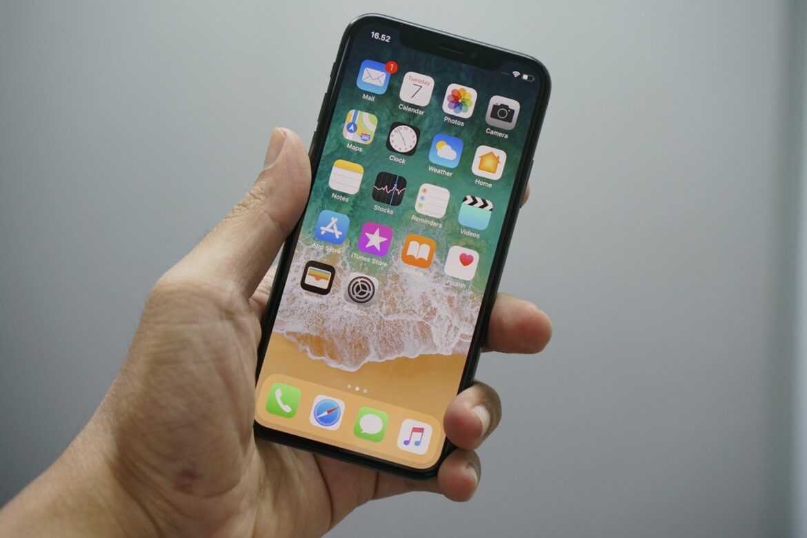 Photo by Bagus Hernawan person holding space gray iPhone 7